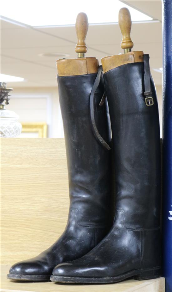 A pair of black leather gents riding boots and trees